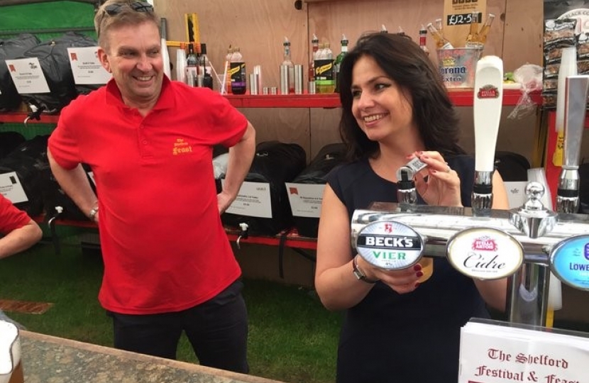 Heidi Allen MP pulling a pint at the Shelford Feast in July.