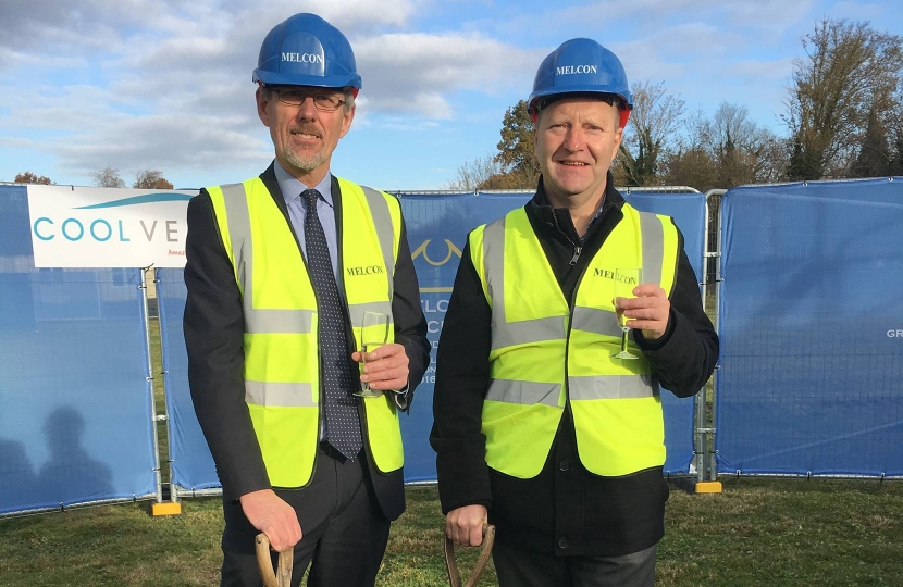 South Cambridgeshire District Councillors Simon Edwards (left) and Robert Turner, responsible respectively for finance and planning, with spades and Champagne on this auspicious day.  Photo credit: South Cambridgeshire District Council.