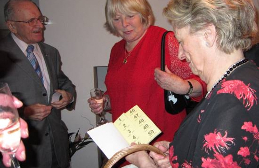 Anne Owen (right) selling raffle tickets.